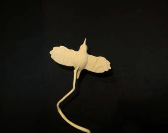 Wooden carving of a trogodyte Ash on a branch of Holly