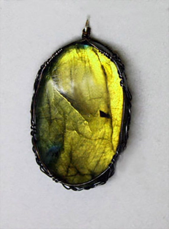Labradorite pendant wrapped in a Celtic style with sterling silver and copper