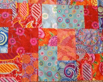 Unfinished Quilt TOP in all Kaffe Fassett fabrics in red, orange, and blue bright colors. 45.5 x 56.5 inches