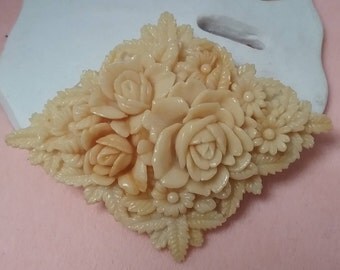 celluloid floral diamond shaped brooch