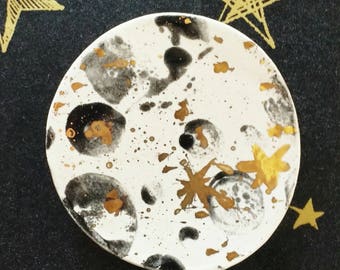 Out-of-this-world sweet little moon brooch. Ceramic, black and white glaze with sparkly splashes and stars of real gold lustre.