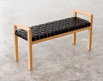 Elegant modern wood-framed bench with woven leather seat