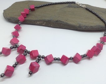 A very vibrant pink magnesite and haematite beaded necklace.