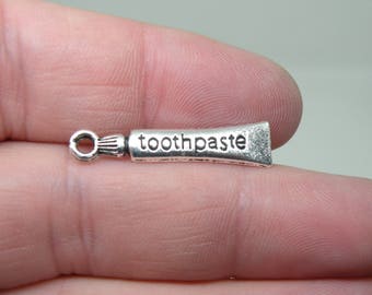 6 Silver Tone "Toothpaste" Charms. B-013