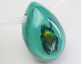 Gorgeous turquoise lucite necklace with real metallic beetle