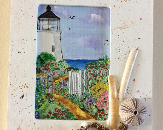 Framed acrylic lighthouse, decorated with seashells