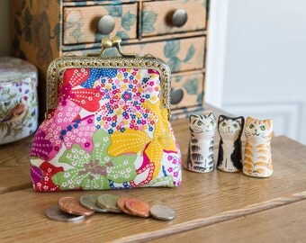 Coin purse made with Mauvey print Liberty Tana Lawn, a golden lining, and a hand stitched bronze colour metal frame