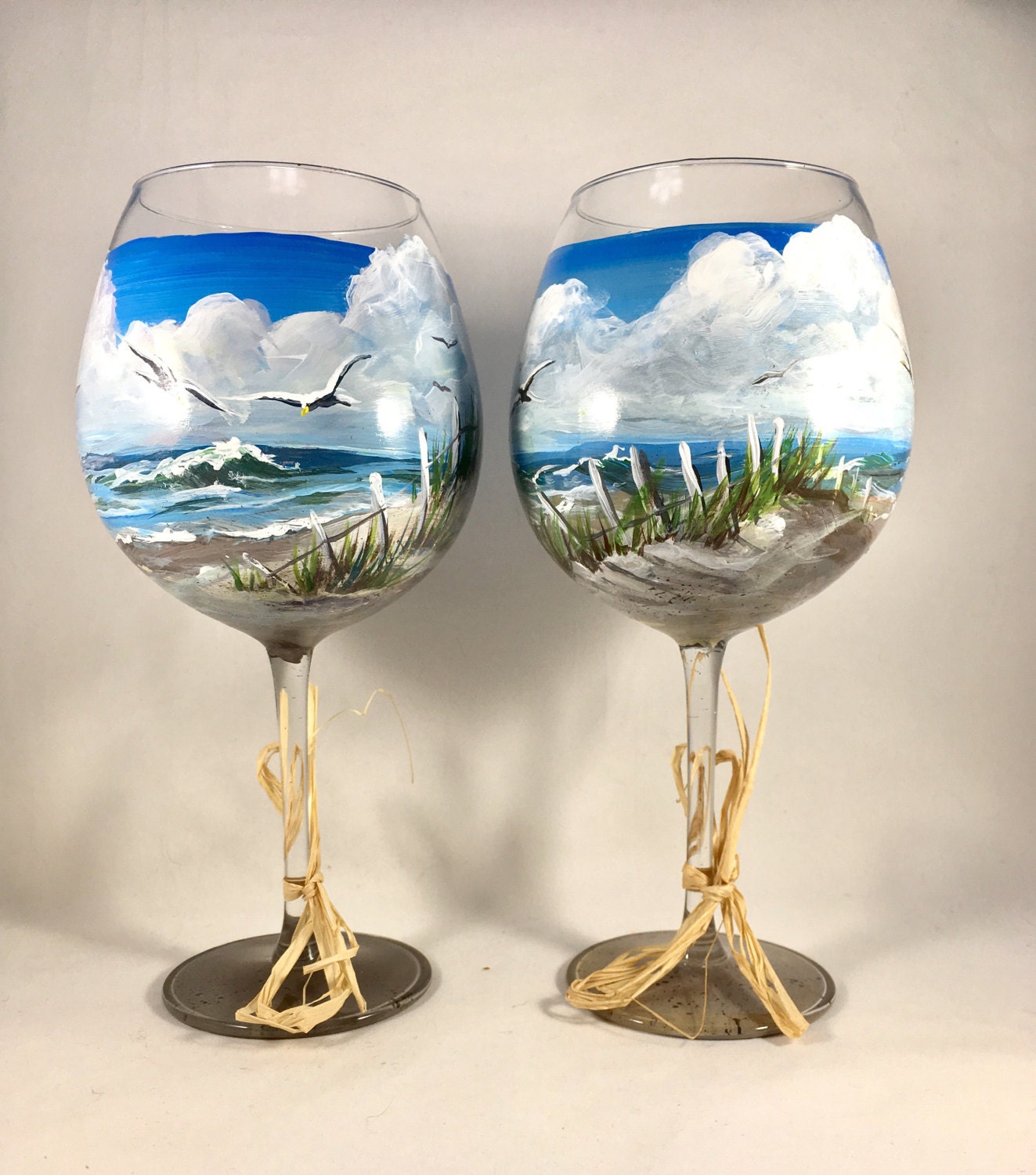 Beach scene wine glasses with surf ocean waves sea gulls and