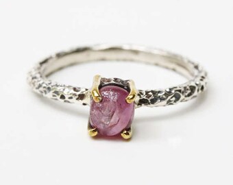 Oval cabochon Ruby with oxidized texture silver band