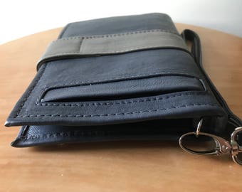 Beautiful luxurious leather phone wallet.Wristlet with 27 card slots, photo windows and pockets. Lots of room. Mini clutch purse