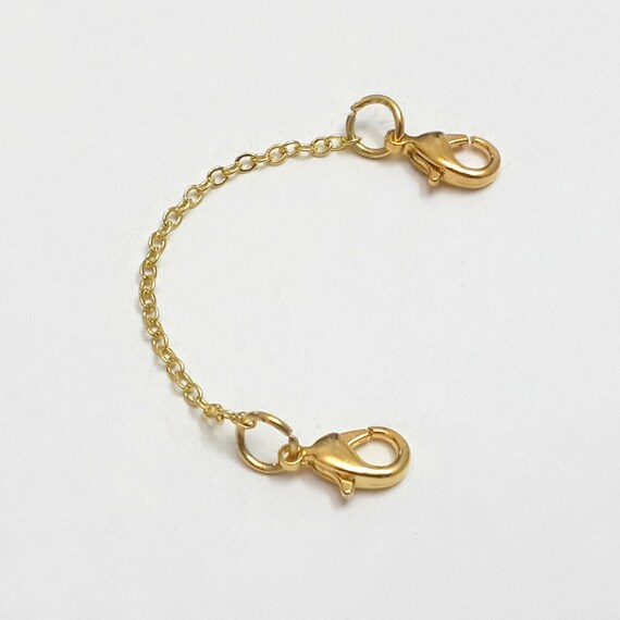 Gold bangle bracelet with safety chain bracelet
