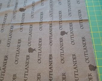 Outlander cotton Print grey With words and Silhouettes 2/3yd