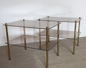 Set of two smoked glass tables with brass-colored frame from the 70s