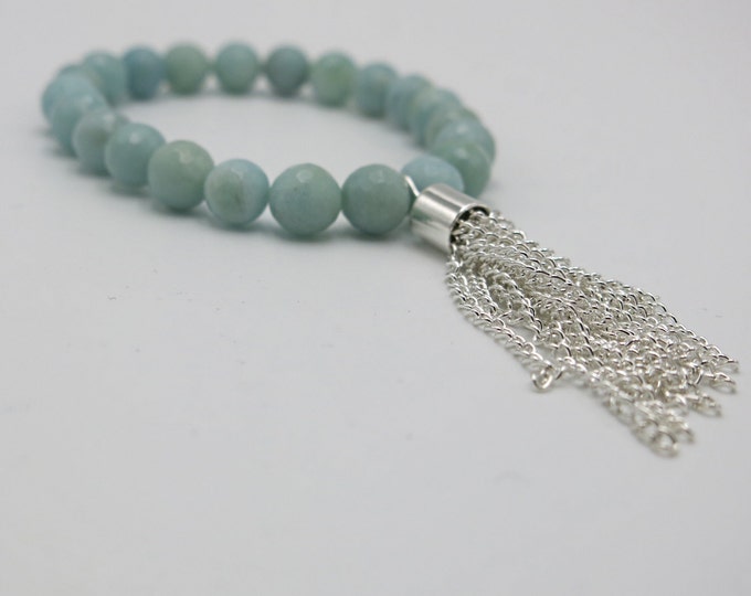 Boho bohemian chic natural green semi precious beaded bracelet with a tassel chain hanging off.