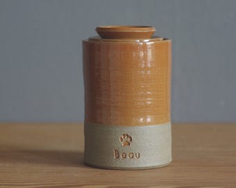 Pet memorial urn with lid. Handmade pottery pet urn or human ashes urn. Sand, rust orange with paw shown. cremation urn for ashes.