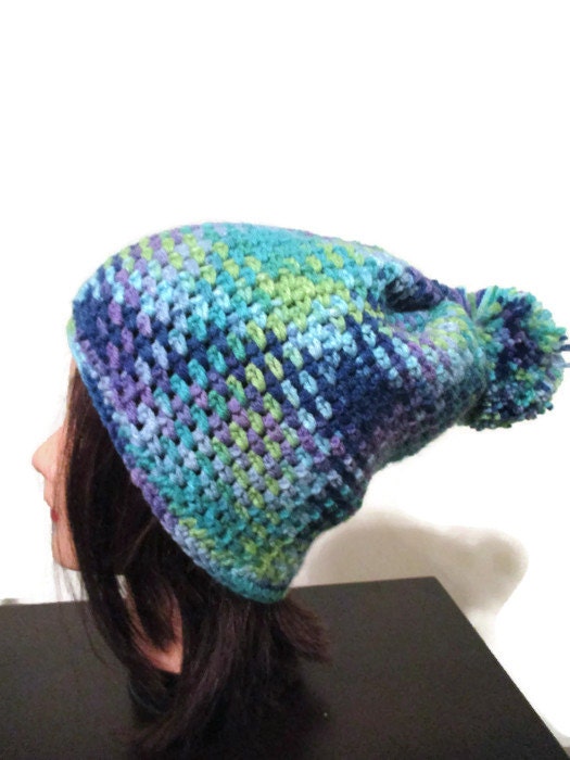 pooled crochet hat in blues greens and purples puff ball hat