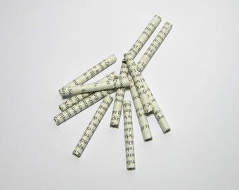 Paper beads scattered parts tinker tubes book pages vintage of decode cards Bastelmaterial recycled books