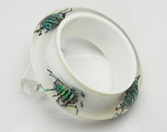 White lucite bracelet with real blue iridescent beetles