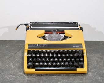 Vintage yellow Sperry-Remington Tenfifty typewriter