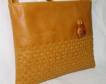 Fur handbag quilted by hand with adornment of the Baltic amber.