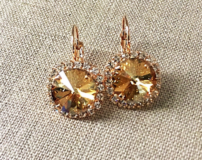 Yellow Swarovski crystal golden shadow canary crystal dangle drop earrings surrounded by a halo of clear crystal on a lever back.