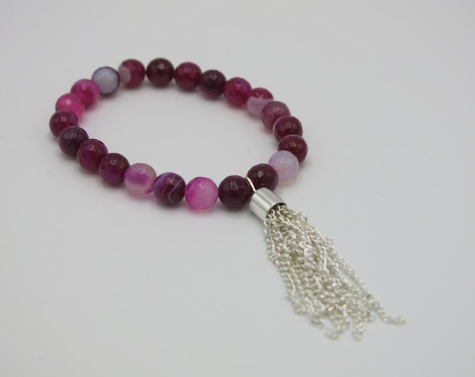 Boho bohemian chic pink striped agate semi precious beaded bracelet with a tassel chain hanging off.