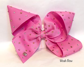Large pink sparkly hair bow by woah bow. Similar Style To bow worn by Jojo siwa at kids choice awards