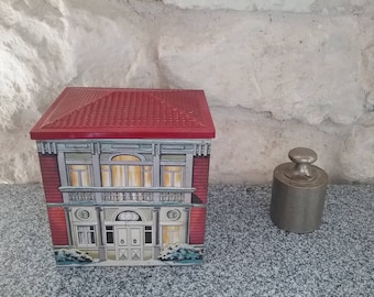 Vintage metal house shaped box. House in winter, snow