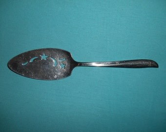 One (1), 9 1/2", Stainless, Pierced, Pie Server, from Community/Oneida, in the 1959 Twin Star Pattern.