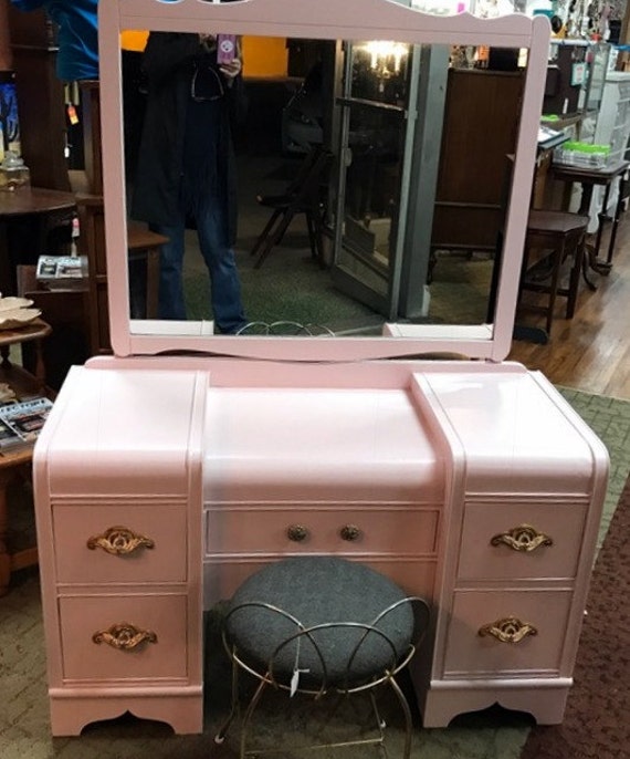 Pink waterfall vanity and mirror