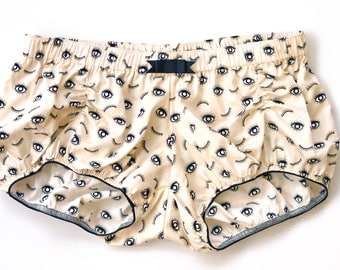 Pair of women bloomers, mid-low waist, beige, eyes and lashes pattern in black and gold, 100% cotton, made to order, women short pajamas