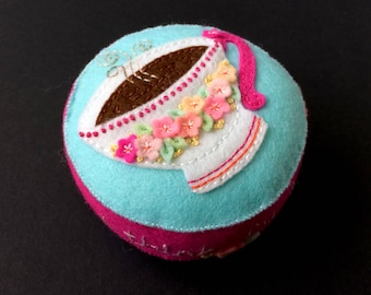 pink and blue wool felt cup pincushion with lots of flowers and hand embroidery