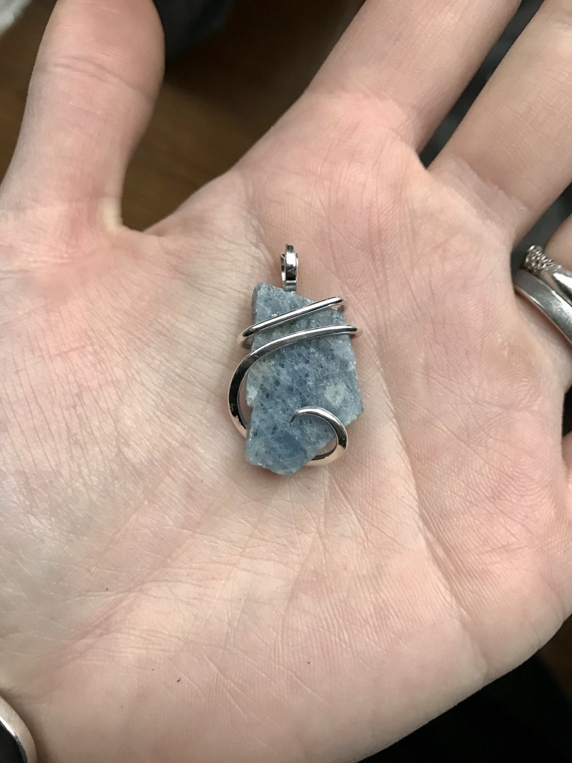 Sapphire crystal tension set in hand forged polished sterling
