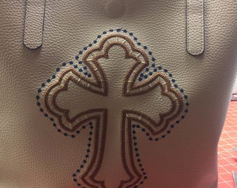 Tote lined with pockets embellished with embroidered cross