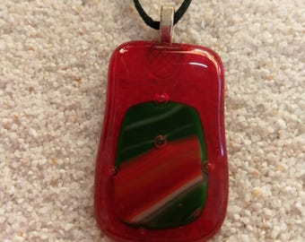 large red clear glass pendant with green and red highlights