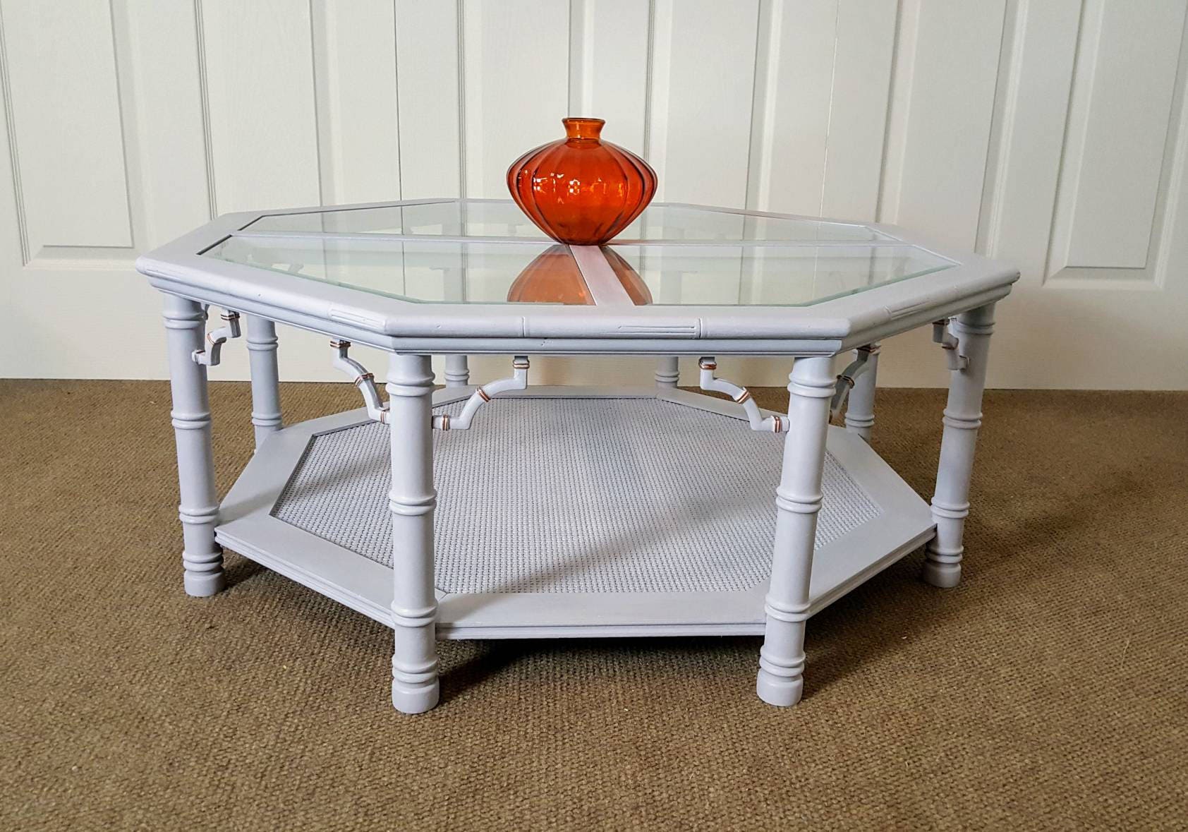 Gray coffee table with glass and bronze details / rattan/