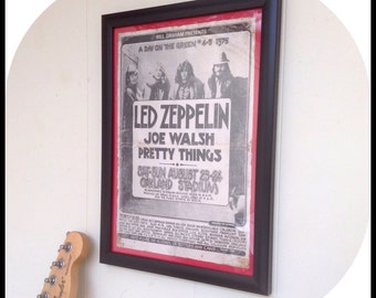 Aged reproduction Led Zeppelin gig poster in frame.