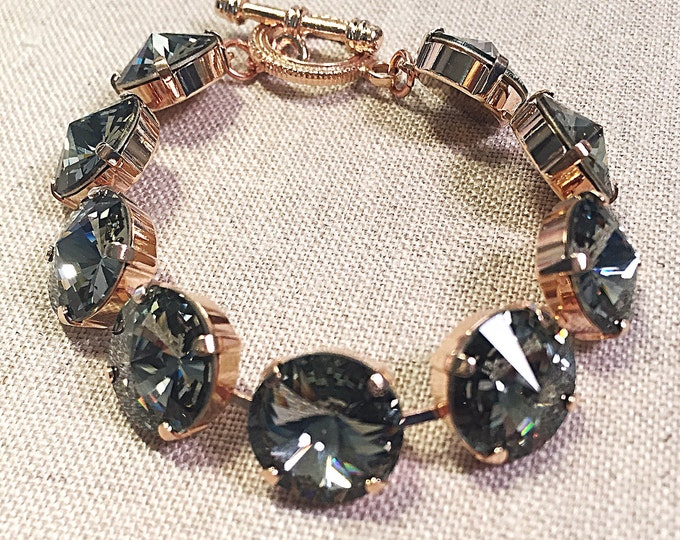 Alluring timeless fashion forward Swarovski crystal black diamond rivoli tennis bracelet that embodies elegance .