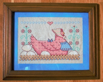 Cross stitch picture. Hen with eggs.