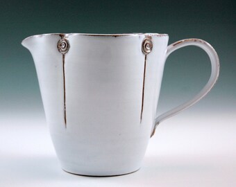 White pitcher,medium size with straight form.