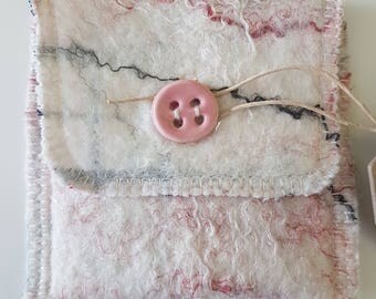 Small wallet in pink and white.