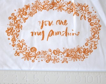 embroidery pattern on fabric You Are My Sunshine tangerine on white
