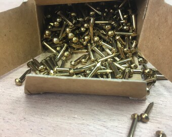 New old stock. Brass eacutheon pins/nails.