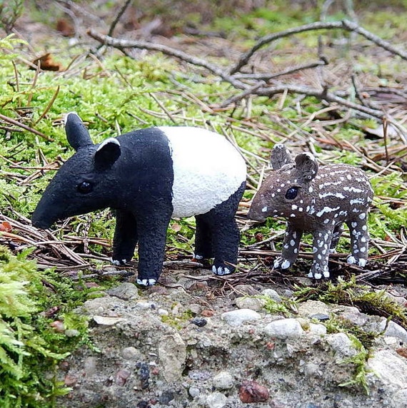 These tapirs are at the edinburgh zoo in scotland. Malayan tapir with baby tapir figurine sculpture by ...