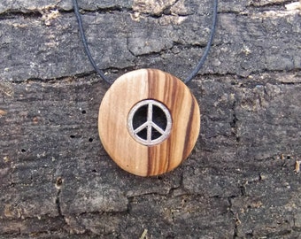 Olive wood pendant with two inlaid peace symbols