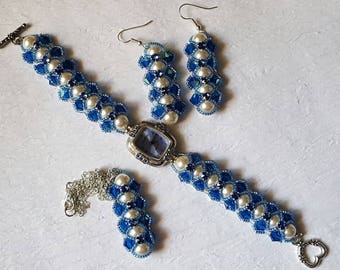 Set of watch, earrings, and necklace of cream Swarovski pearls with Capri blue bicones and light seed beads crossing blue Swarovski montees