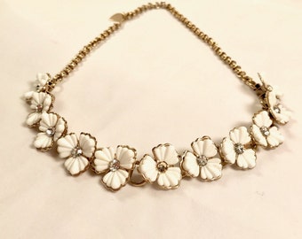 Vintage Thermoset Necklace. cream colored flowers with clear rhinestone centers. Measures 15 inches, gold tone chain, hook and tail closure