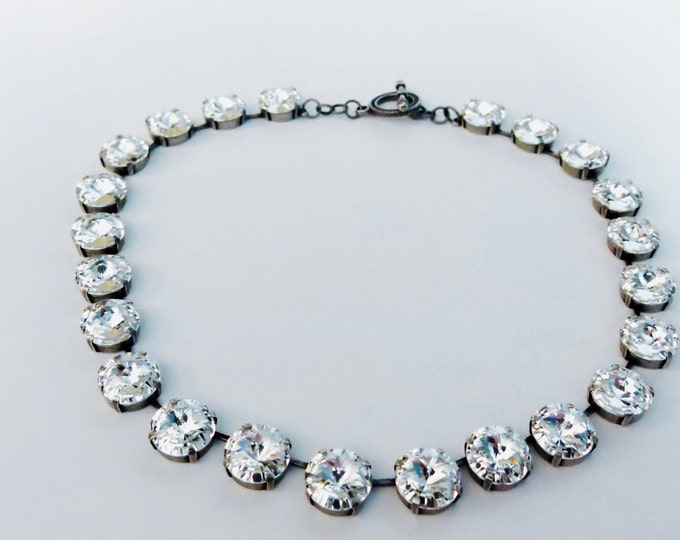 Luxurious 14mm genuine Swarovski crystal rivoli stones set in a timeless collar necklace. Anna Wintour style large crystal necklace.