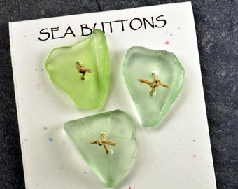 Set of three double drilled natural glowing sea foam green heart shaped sea glass buttons from Maine for fiber artists and jewelry craft