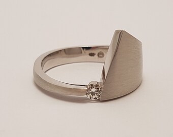 White gold ring with brilliant cut diamond. Unique style made by Cober.
